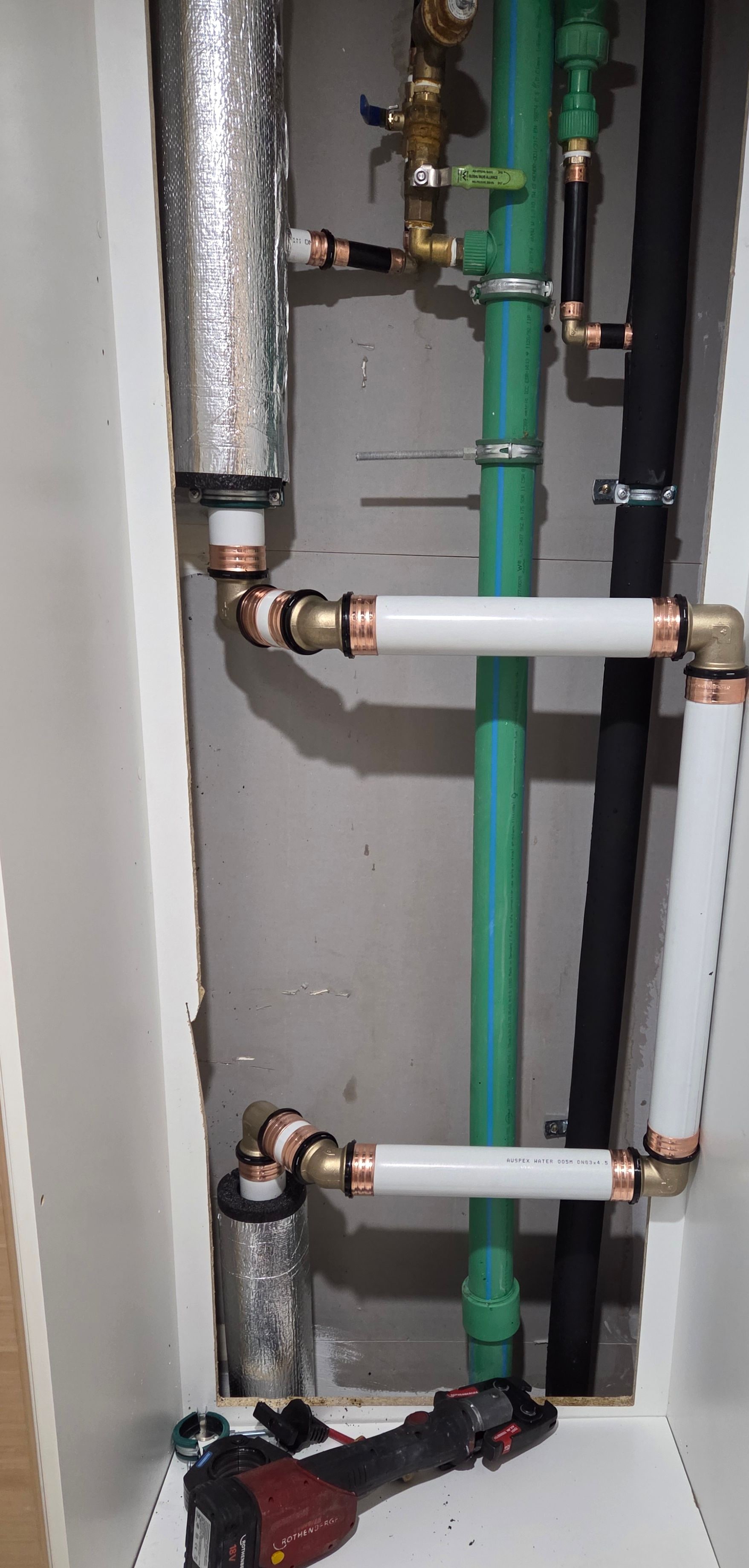 Apartment service cupboard during hot-water fit-off at Adagio Apartments